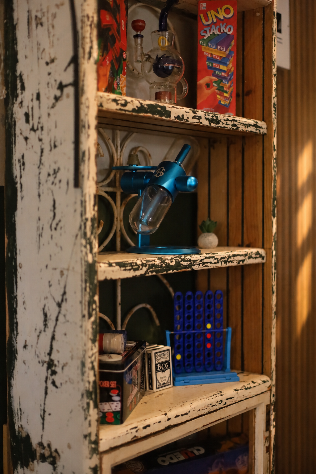 Board games and glassware on a rustic Herb Heaven shelf