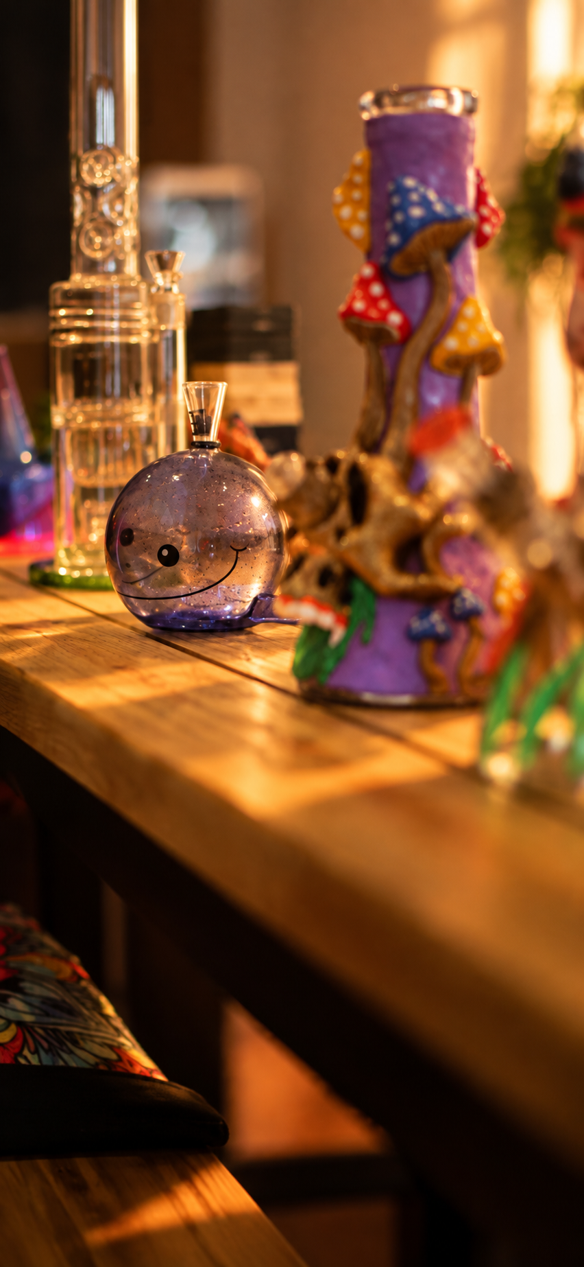 A smiling purple glass piece on the wooden display table